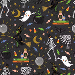 A repeating Halloween pattern on a dark charcoal background featuring cartoon skeletons, ghosts, witches on broomsticks, cauldrons, potions, stars, candy corn, cobwebs, and moons in black, white, orange, yellow, green, and blue.