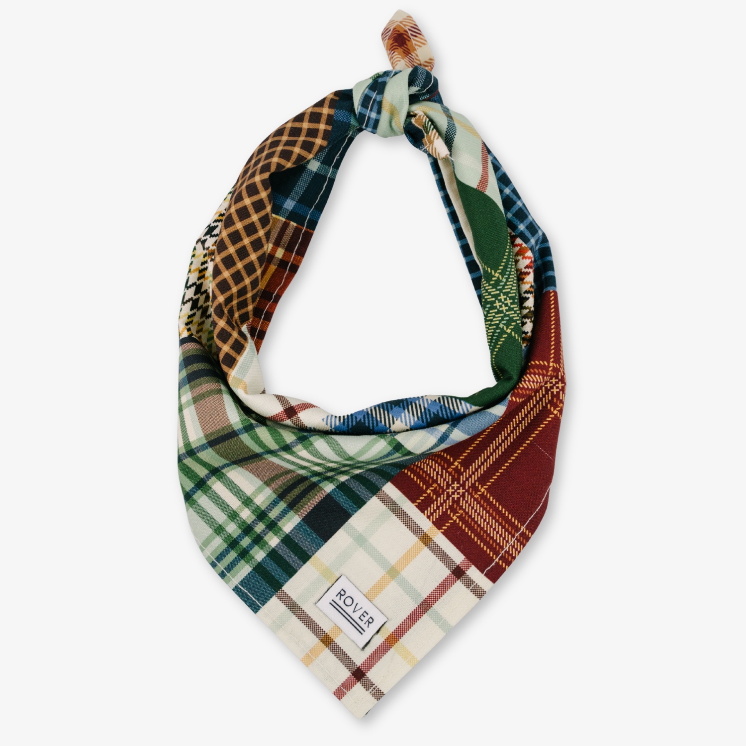 A multicolor patchwork plaid dog bandana with a knotted top and a visible 'SOBER' brand label, displayed on a clean white background.
